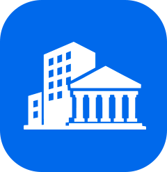 White icon of a cityscape with a tall building and classical government or bank building on a blue background.